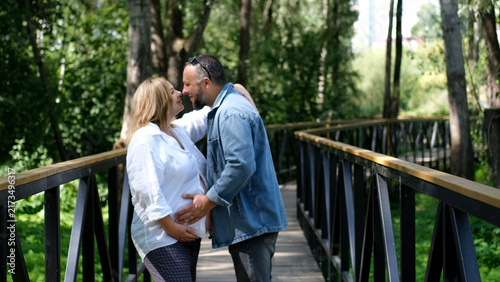 Fotografie Expectant Couple Together in the Park, Pregnant Woman and Partner, Family Love,