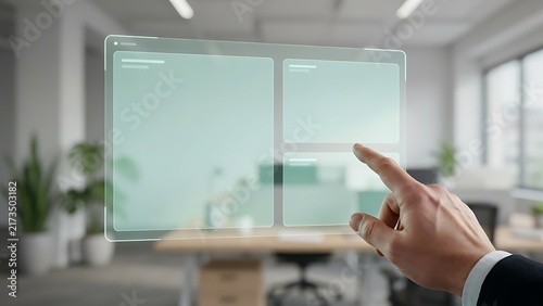 Hand touching a transparent digital interface screen with blank rectangular data panels in office