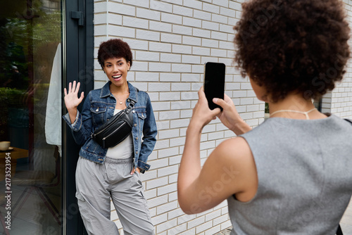 Photography Two beautiful young women enjoy their time together, capturing memories outside a stylish building