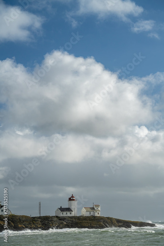 Bild auf Leinwand Landmark beneath vast sky places Langoytangen lighthouse low in a vertical frame under large bright clouds in Norway for coastal scale, copy space and regional travel layouts