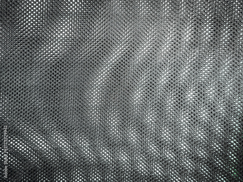 Mesh background shows fabric weave with backlighting. Double pattern shows swirl effect with highlights & shadows in uneven spiral. 