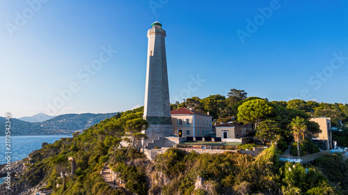 Фотография Aerial drone view of the Phare du Cap Ferrat lighthouse surrounded by pine fores