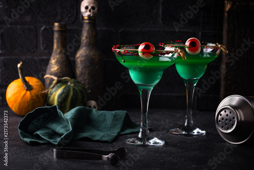 Spooky green Halloween monster cocktail with eyeball