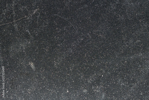 Dark Granular Matte Surface Texture Background with Fine Particulate Matter and Subtle Imperfections Softly Focused for Ample Copy Space