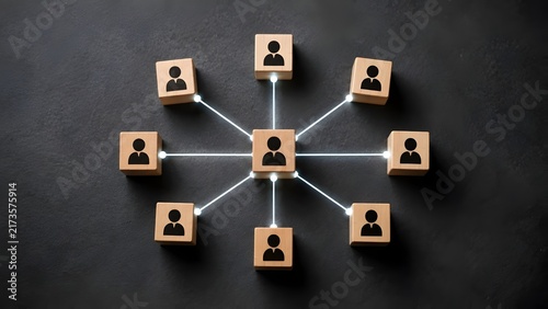 Organizational structure and team management concept featuring wooden blocks with human icons connected by glowing lines on dark background