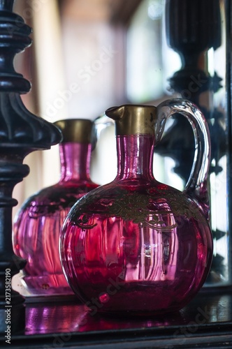 Reddish glass vase in front of a mirror, framed black and white portrait of an Indian nobleman, Chapslee Hotel, former summer residence of Raja of Kapurthal, Elysium Hill, Lakkar Bazar, Shimla, Himachal Pradesh, North India, India