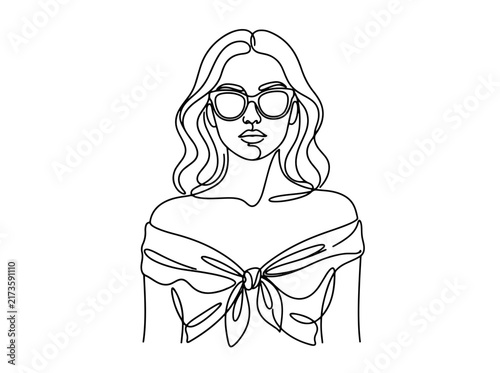 Woman with wavy hair and large bow wearing sunglasses