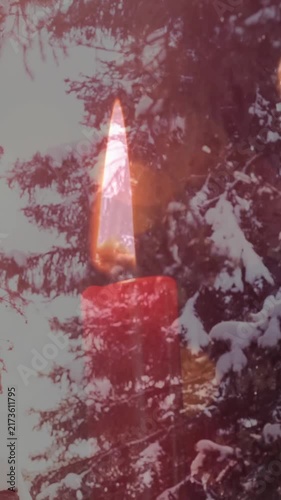Animation of candles over winter coniferous trees with snow