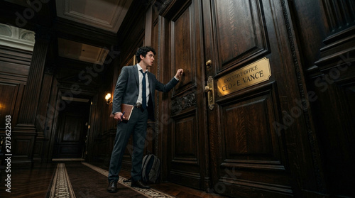 Young Businessman Knocking on CEO Executive Office Door for Meeting