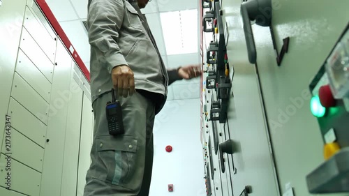 Electrical technician performing Lockout Tagout on a power distribution panel after verifying electrical conditions, demonstrating safe maintenance practices, energy isolation, hazard prevention, and 