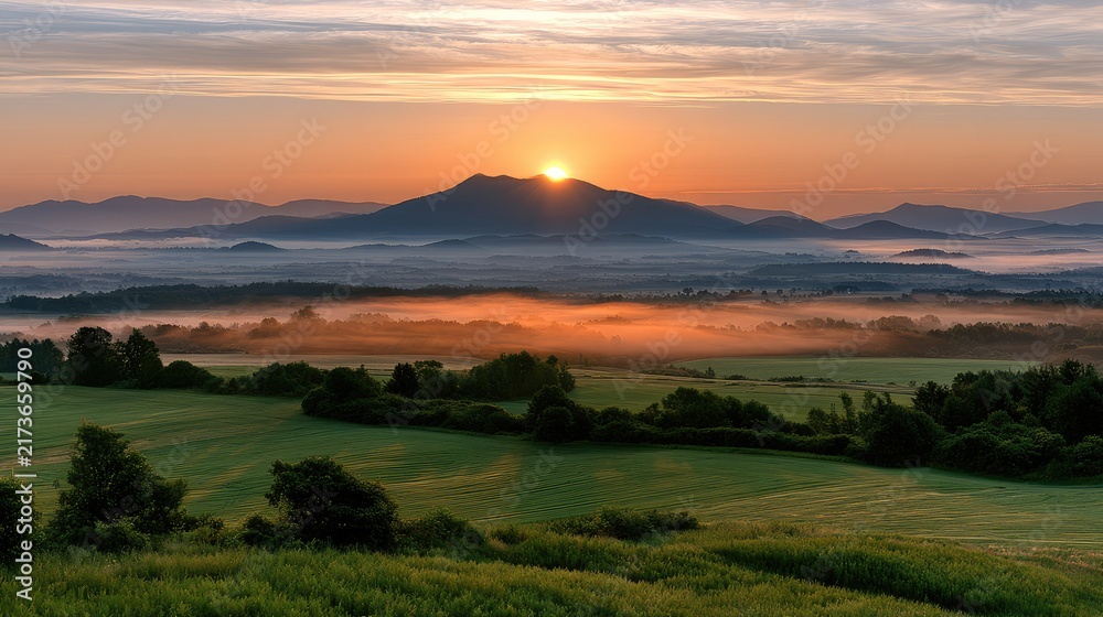 Fototapeta premium Stunning Sunrise Over Misty Mountains in Lush Green Landscape