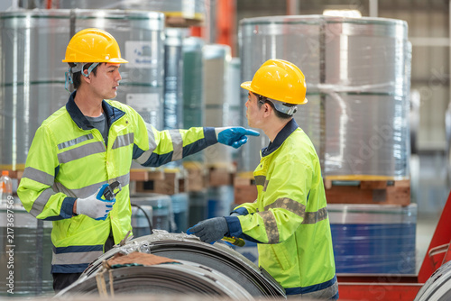 Konstfotografi Teamwork technician discussing metal sheet machine system operation collaboratio