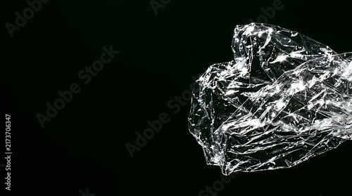 Crumpled Clear Plastic Wrap Texture on Black Background