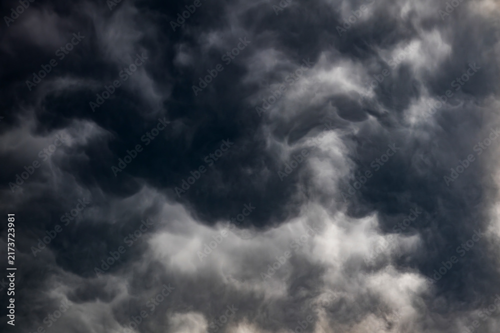 Fototapeta premium Dramatic dark storm clouds gathering in the sky overhead