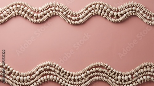 Two wavy decorative gold metallic ribbons forming a frame on a solid dusty pink background