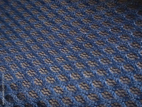 Close up of blue mesh fabric texture with a blue honeycomb pattern