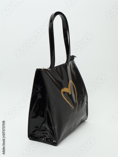Bild auf Leinwand Black Patent Leather Women Tote Bag with Gold Heart Print Isolated on White Back