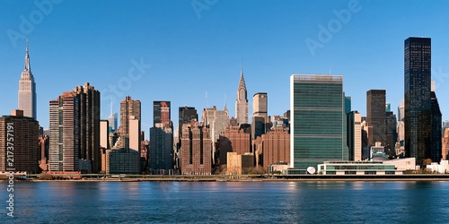 Manhattan skyline panorama with river and blue sky