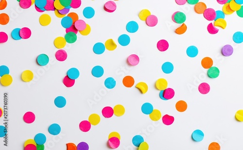 Colorful confetti scattered on white background