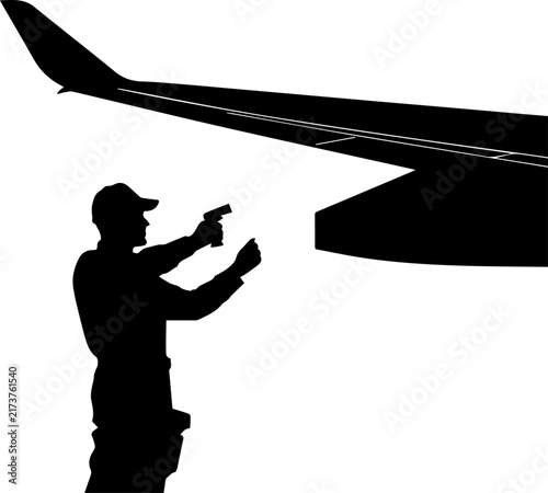 Canvastavla Silhouette of a man holding a gun near an airplane wing representing an aviation