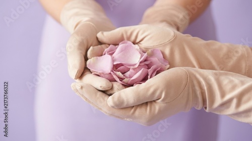 Hands in Pink Protective Gloves Cupping Fresh Rose Petals on Pastel Background