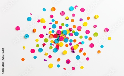 Colorful confetti scattered on white background