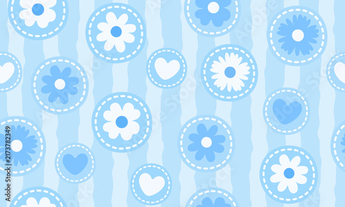 Cute blue seamless pattern with floral and heart motifs inside stitched circular patches over a soft wavy striped background, ideal for fabric