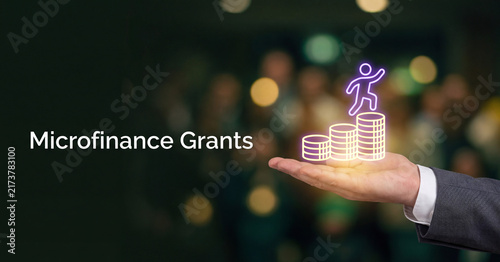 Microfinance grants represented by a business person holding glowing neon coins and a climbing human icon for financial growth, investment banking, and corporate funding success