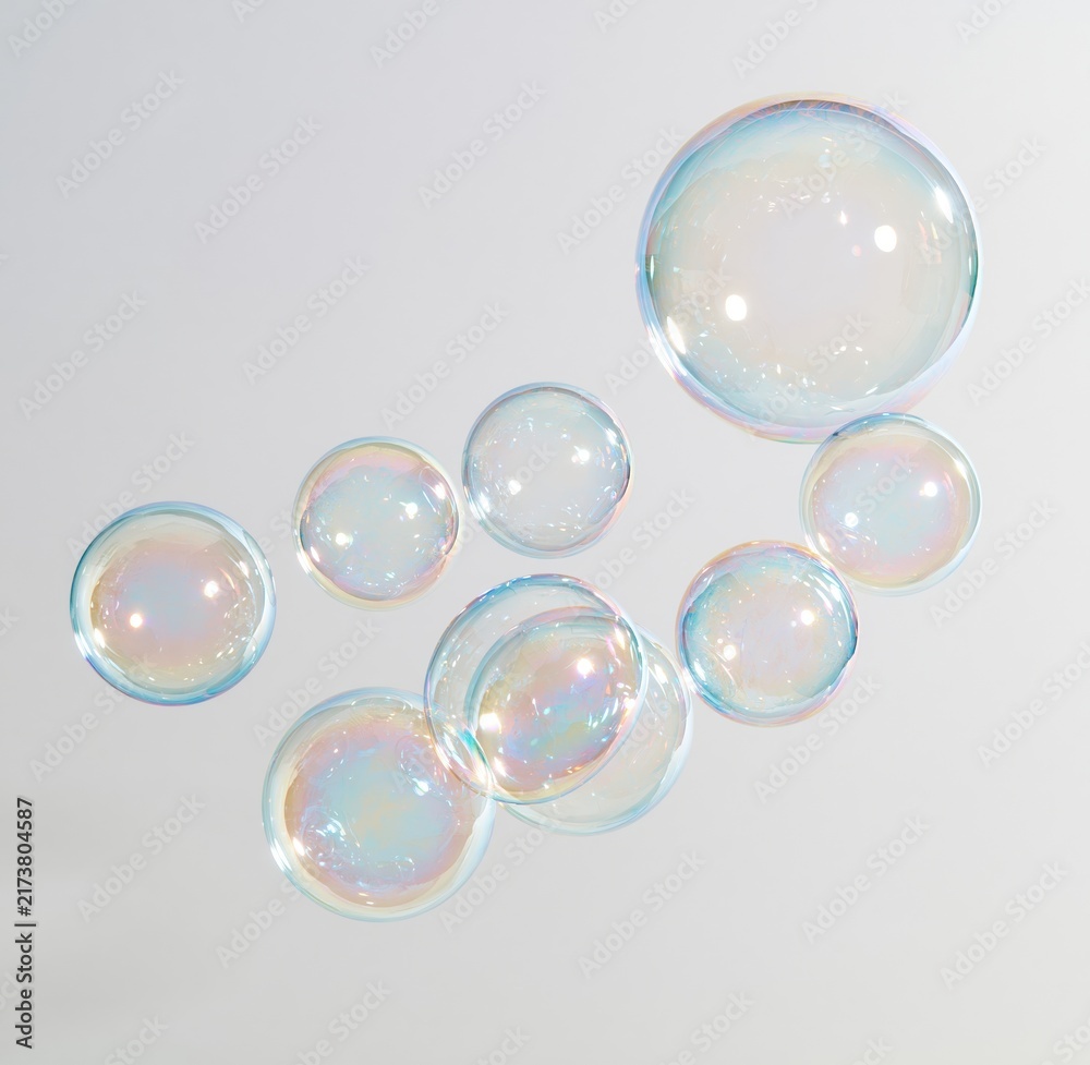 Obraz premium Colorful iridescent soap bubbles floating against white background