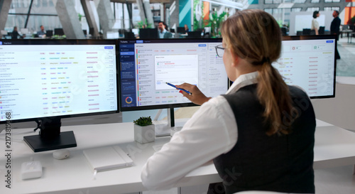 Fotografie Young Woman Working Quickly On Help Desk Tickets
