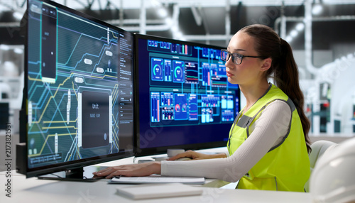 Young Female Engineer Works On Multilayer Circuit Board Design