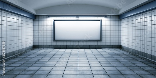 Empty tiled subway station tunnel with blank illuminated