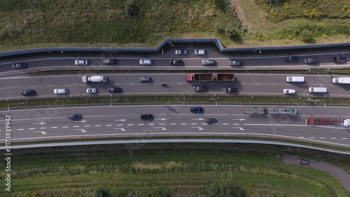 Top-down aerial view of highway traffic flow and freight transport for smart city mobility and global logistics networks