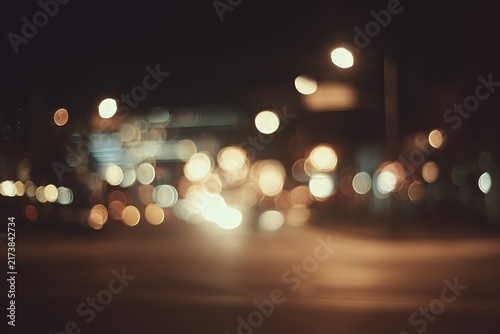 Blurred city lights at night create a dreamy atmosphere.