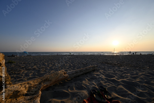 People enjoying sundown at tuscany beach. Togetherness at italian beach. Marina di Torre del LAgo, Tuscany, Italy, Europe.