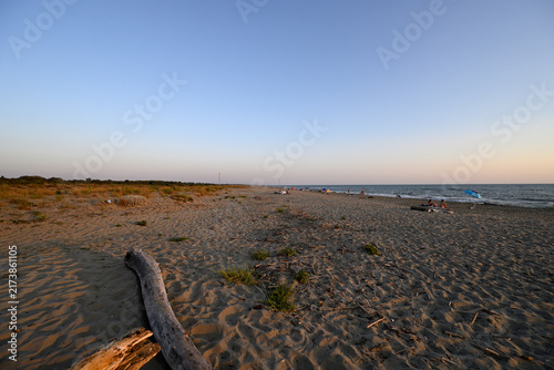 People enjoying sundown at tuscany beach. Togetherness at italian beach. Marina di Torre del LAgo, Tuscany, Italy, Europe.