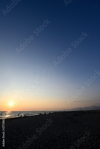 People enjoying sundown at tuscany beach. Togetherness at italian beach. Marina di Torre del LAgo, Tuscany, Italy, Europe.