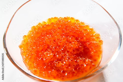 Canvas Print Fresh salmon roe ikura marinated in soy sauce served in a clear glass bowl, vibr