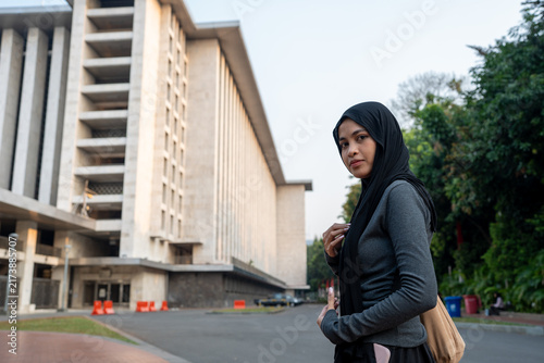 Принти на полотні Indonesian muslim woman standing in front of mosque