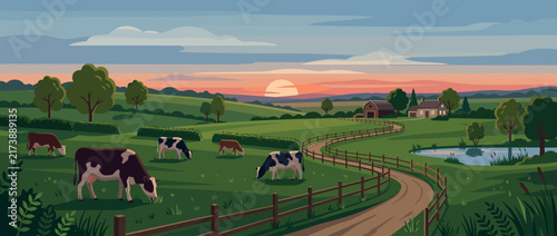 Cows grazing in a lush green countryside pasture at sunset.