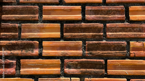 Konstfotografi A close-up of brickwork with dark joints and uneven brick surfaces
