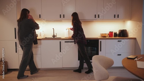 Cooking and cleaning in a cozy kitchen during evening hours