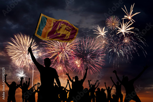 Silhouette man with flag of Sri Lanka and Holiday fireworks