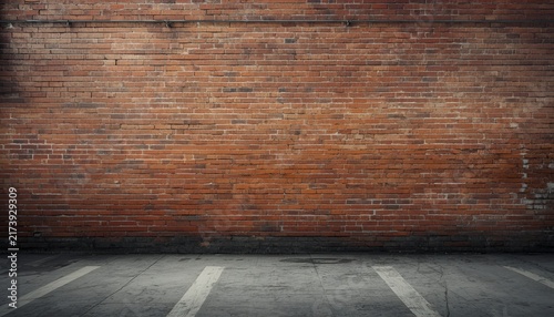 Empty Urban Industrial Street with Weathered Warehouse Brick Wall, Grunge Concrete Texture and Atmospheric City Background for Text and Graphic Design