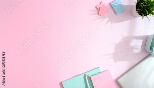 Pastel Stationery Arranged on Pink Desk with Plant and Copy Space