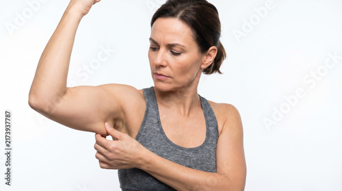 Woman Flexing Arm and Examining Upper Arm Muscle Tone