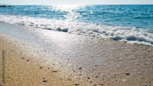 Gentle Ocean Waves Lapping on a Sunlit Sandy Beach