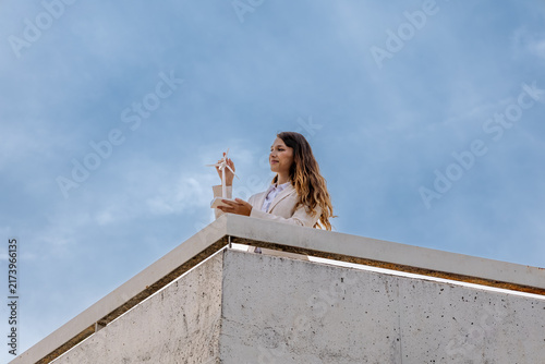 Fotografie Woman holding wind turbine model envisioning renewable energy