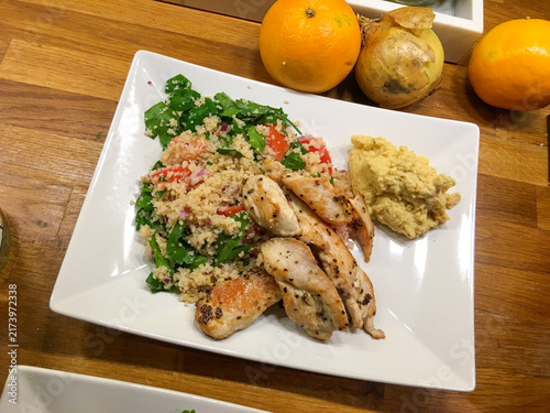 Grilled chicken with couscous salad and hummus