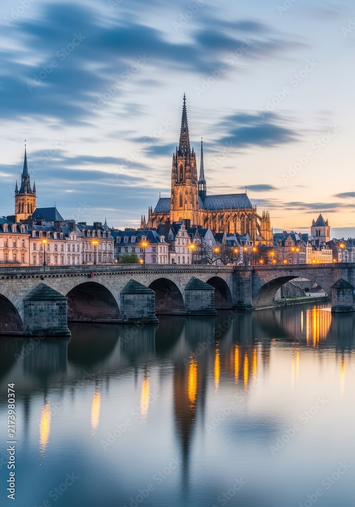 Fototapeta premium Wide scenic view of a historic riverside city featuring stone bridges, classic architecture, and old cathedrals under a soft cloudy sky, twilight, scenery, dawn